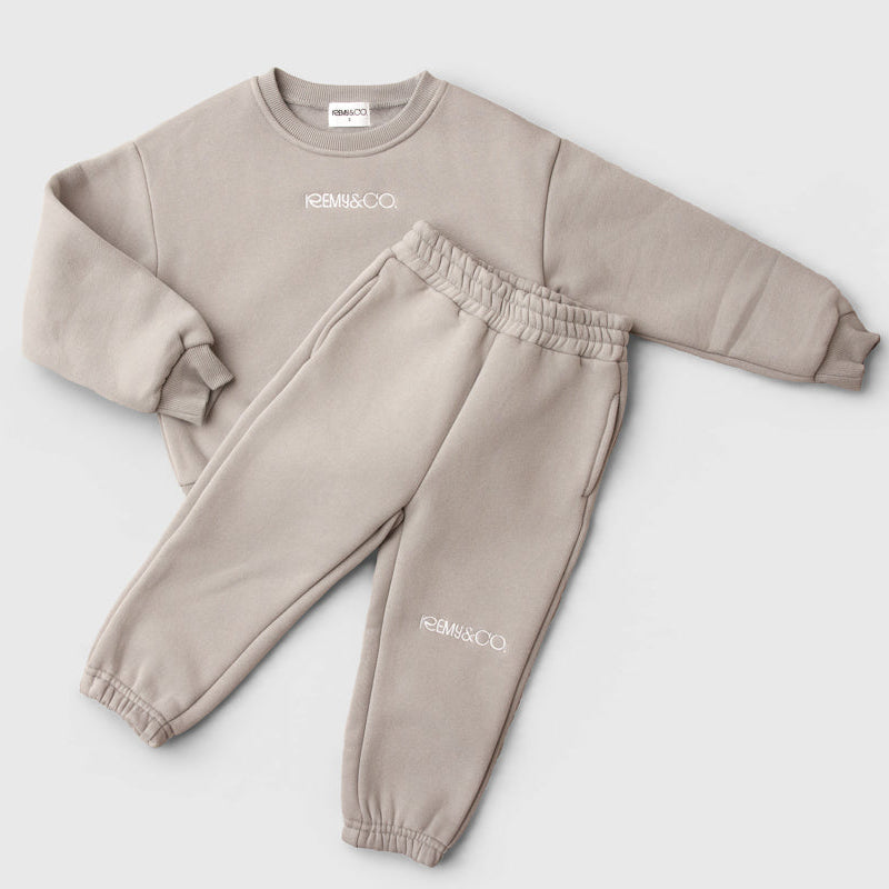 Remy & Co. Dark Grey embroidered crewneck sweatshirt and matching joggers laid flat.