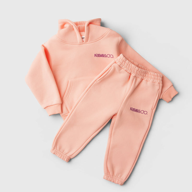 Remy & Co. Pink Puff Print Hoodie Tracksuit Set with matching joggers laid flat.